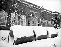 Snow on large concrete pipes in front of Fogg Museum