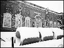 Snow on large concrete pipes in front of Fogg Museum