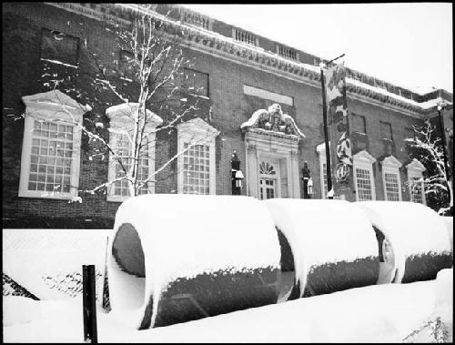 Snow on large concrete pipes in front of Fogg Museum