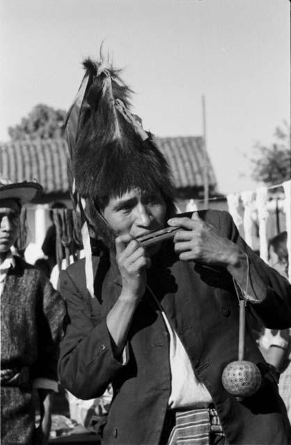 Man with fur hat and harmonica