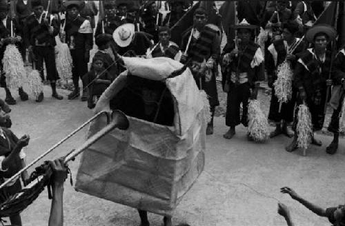 Person in bull costume with musicians