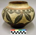 Pottery olla. Black and red floral design on white.