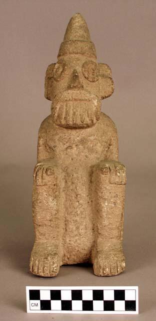 Stone seated figure with hat and prominent teeth.  Tlaloc image in Toltec style.