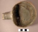 Fragments of pottery ladle--solid round handle. restorable. black-on-white