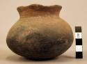 1 small pottery vessel constricted mouth and circular body