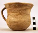 Pottery cup with band handle, impressed decoration