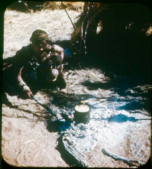 Slide from Marshall Expedition: "Bushmen, Family hearth, sit around this, sleep inside"