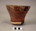 Bowl or goblet painted with geometric motifs and trophy heads