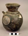 Ceramic jar, round body, flared neck, broken strap handle, flat base, black