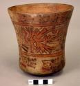 Vase painted in polychrome with two trophy head beings and rows of trophy heads