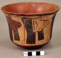 Ceramic bowl, flared rim, decapitated head motif on exterior, mended