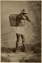 Studio portrait of Maya man carrying a box