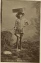 Studio portrait of Maya boy balancing a box on his head