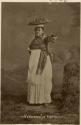 Studio portrait of Maya woman carrying fruit