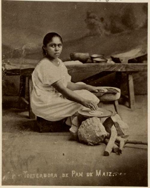 Studio-staged portrait of a woman making tortillas