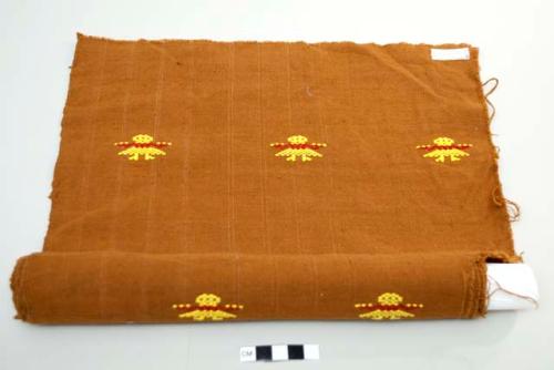 Fabric; brown cotton with yellow and red cotton brocade figures