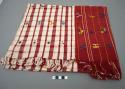 Huipil, woven cotton, red and white plaid, brocade multi-colored human and animal figures, fringed ends