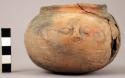 Small earthen jar, with face