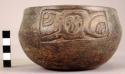 Plain dark brown carved pottery bowl, dimpled base