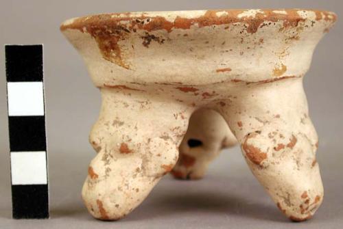 Small tripod pottery vessel with effigy feet