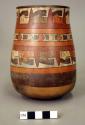 Vase painted in polychrome with spiked band with trophy heads