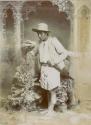 Studio portrait of Maya man holding sheathed blade