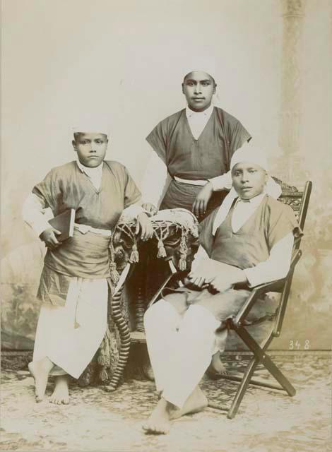 Studio portrait of three Maya boys, students