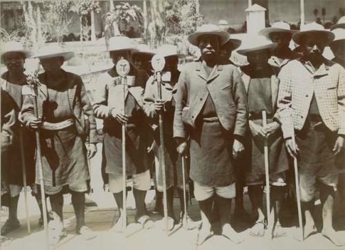 Group portrait of Maya men holding religious staffs