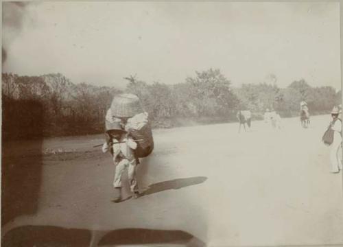 Man carrying large load on back