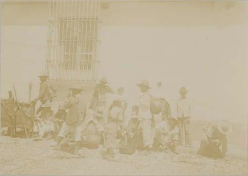 Maya people grouped on side of street