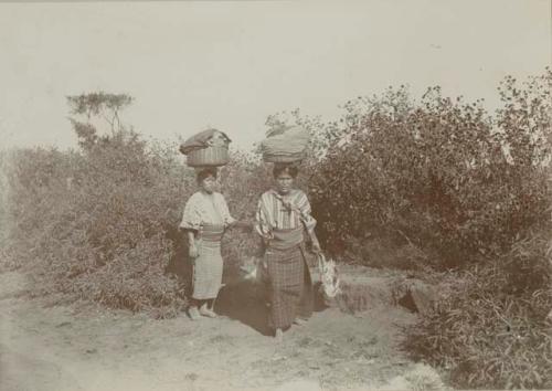 Maya women carrying baskets