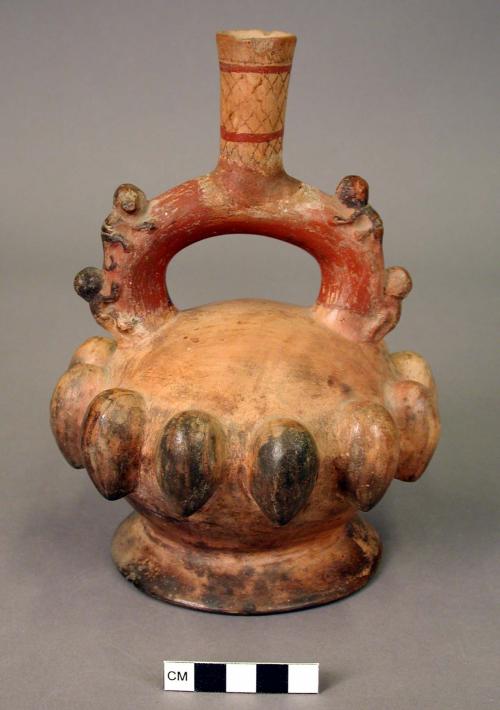 Bottle.clay stirrup spout bottle, a row of fruits around the center.