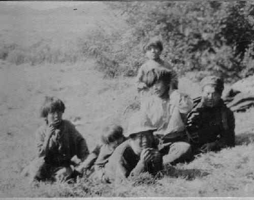 Group sitting in field, Ona Camp NE of Lake Fagnano