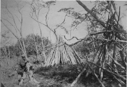 Abandoned Ona camp showing remains of houses burned on death of the occupant.