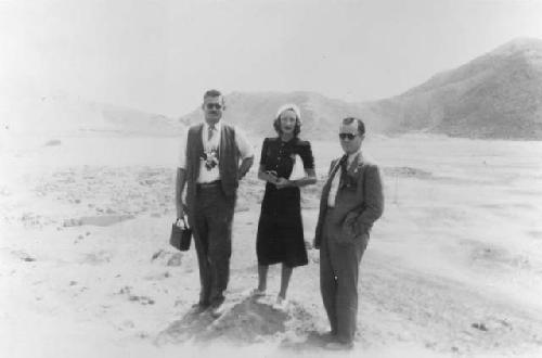 Ethnographic photos in field, three people standing