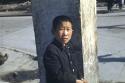 Boy standing in front of column