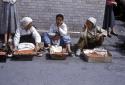 Women fruit vendors sitting on a street
