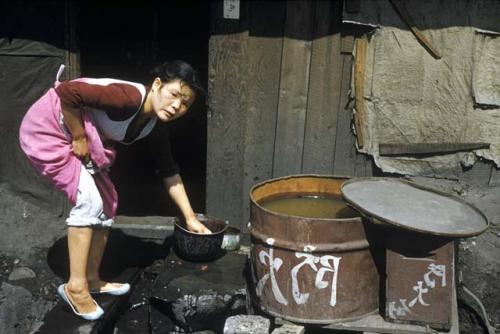 Woman reaching into a pot