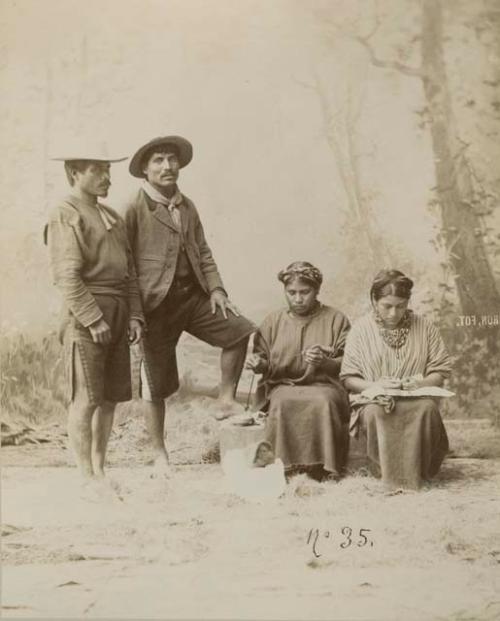 Studio staged portrait of two Maya men and women