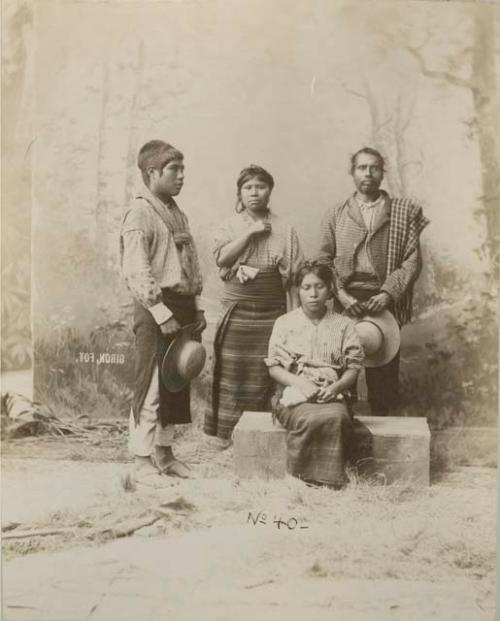 Studio portrait of two Maya men and women