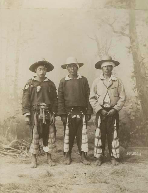 Studio portrait of three Maya men