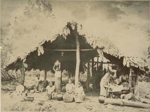 Camp with Indian woman making tortillas