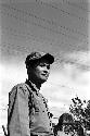 Man standing beneath powerlines