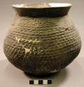 Restored corrugated pottery jar