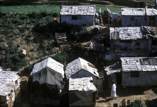 White rooves of houses, with woman walking by