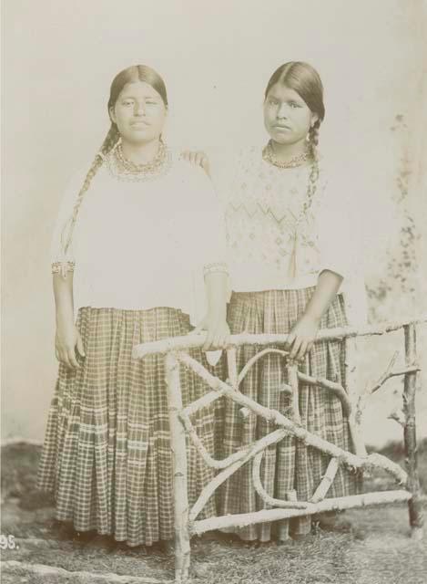 Posed studio portrait of two Maya women