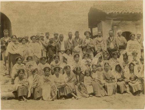 Group at Cotzal, in the rear rank are four half breed men in front are four half breed women and girls