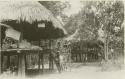 Chocó woman climbing into raised house