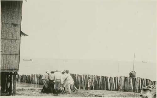 Men crowded around boat