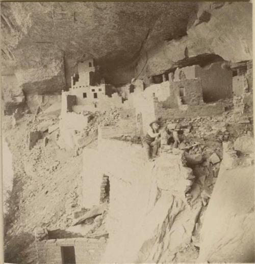 Frederic Ward Putnam climbing wall of room at Cliff Palace